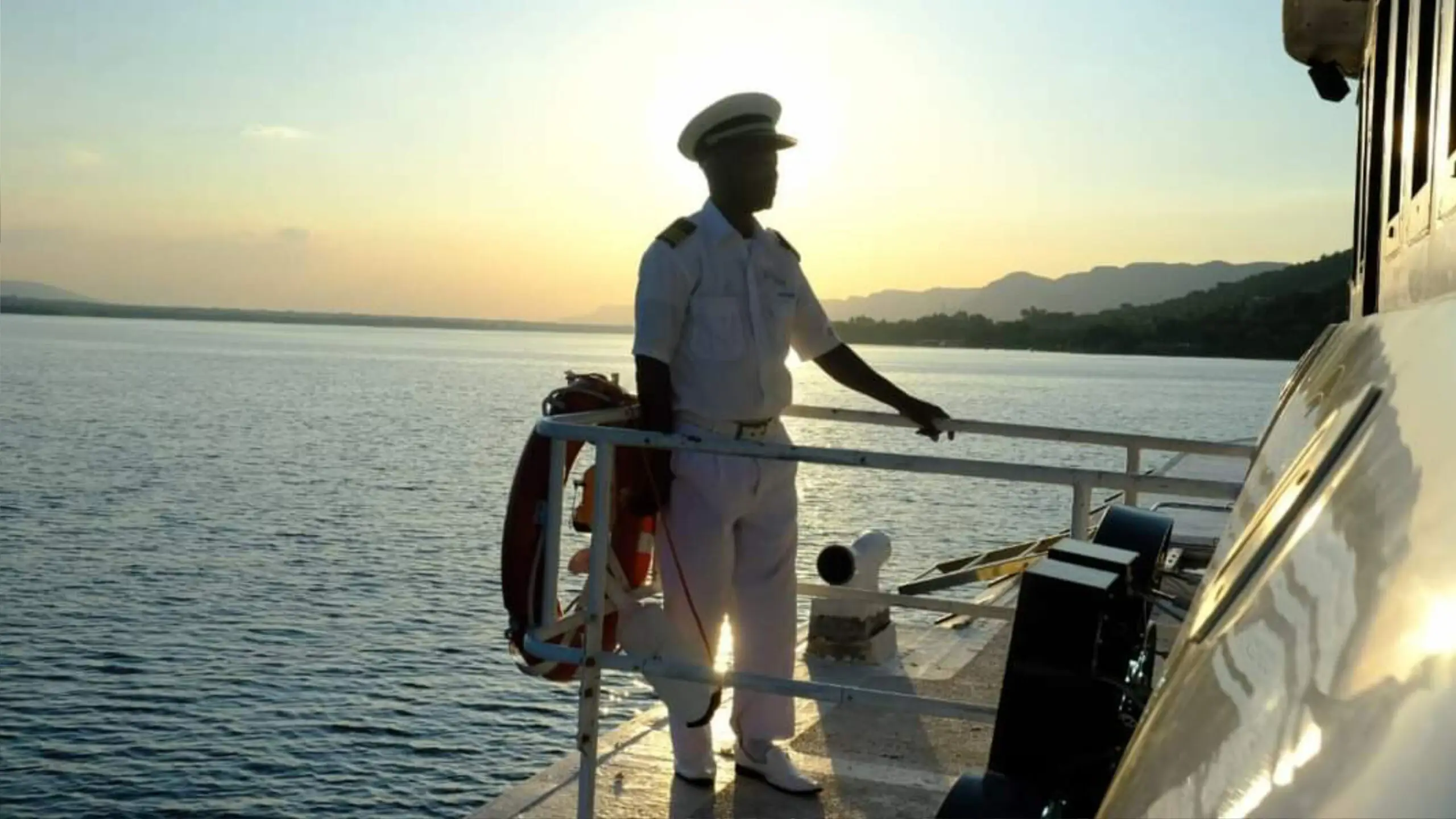 The skipper on deck at sunset