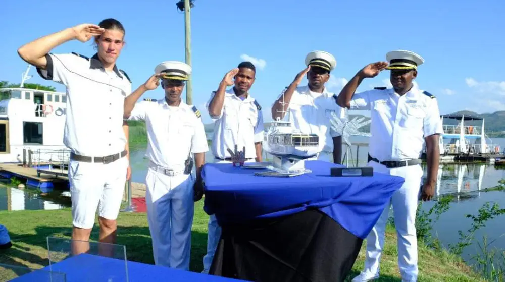 The Alba's crew in whites, saluting