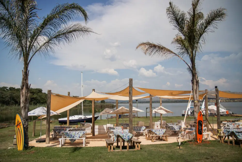 Sun umbrellas and palms on the beach at Harties Harbour