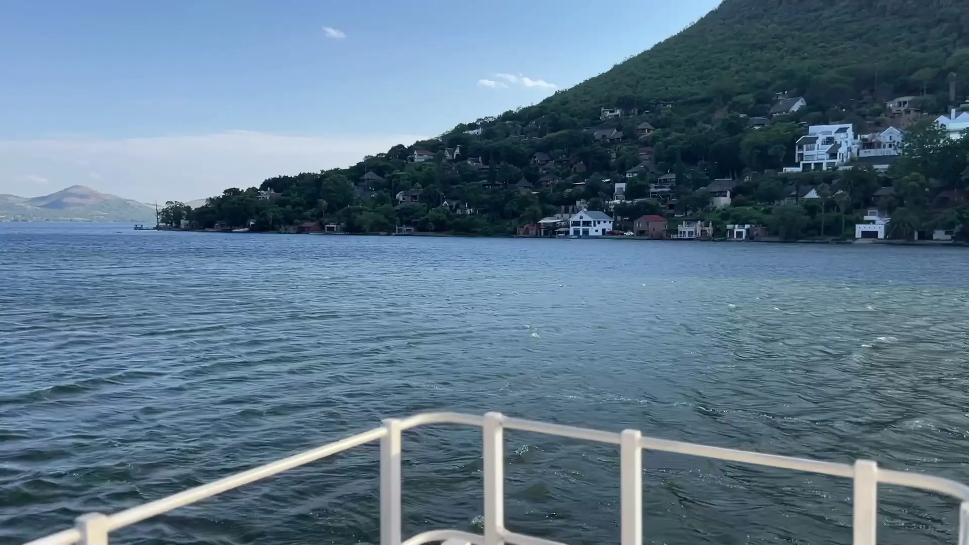 The wake off the stern, with houses on the hillside