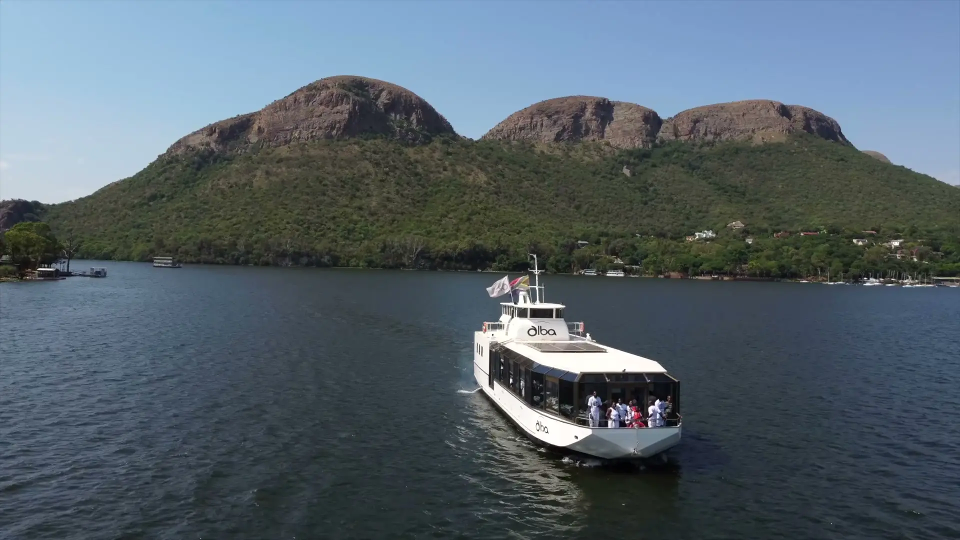 The Alba on the dam beneath the Magaliesberg's rounded peaks