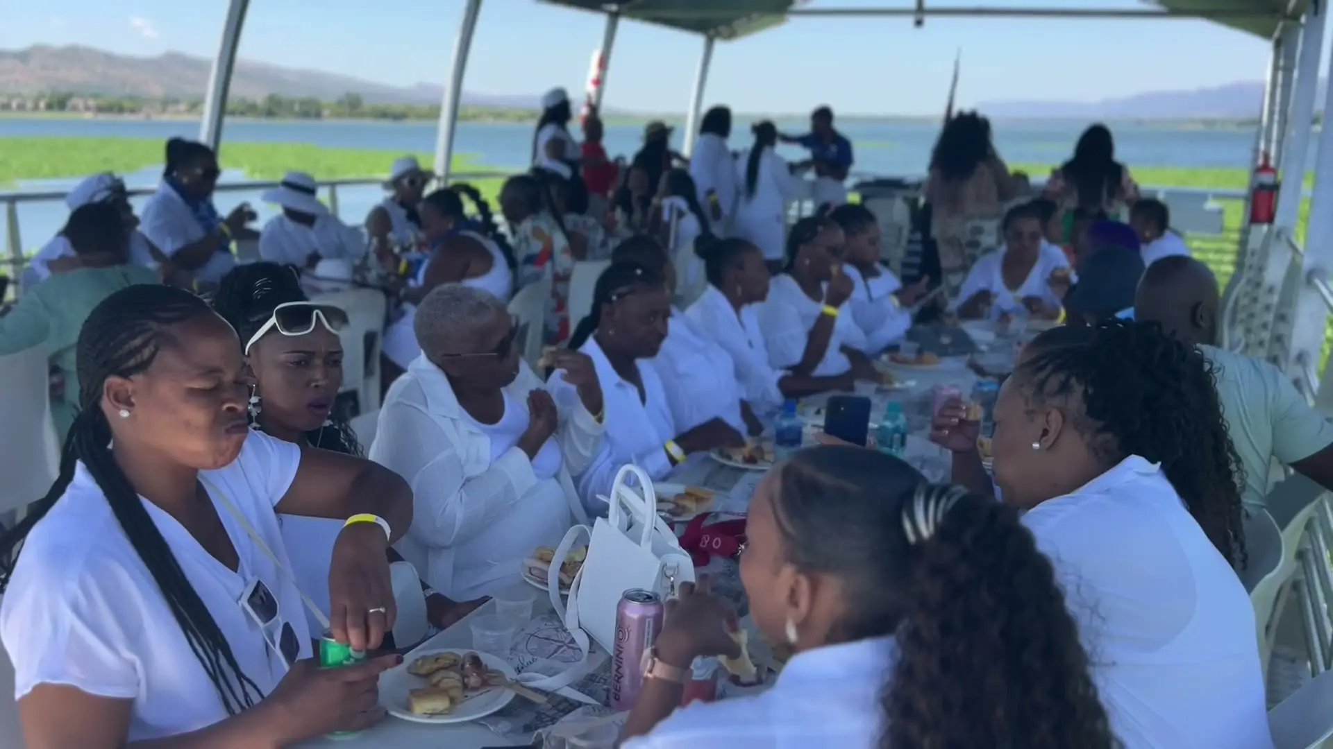 An all-white party at long tables on Danny Buoy's deck
