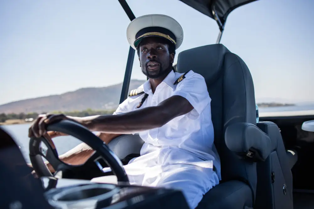 The skipper at the helm in whites