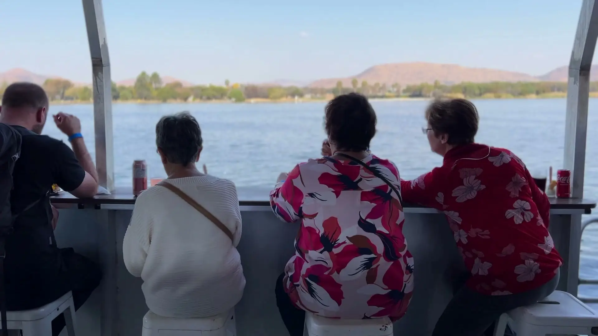 Guests at the rail looking out across the water